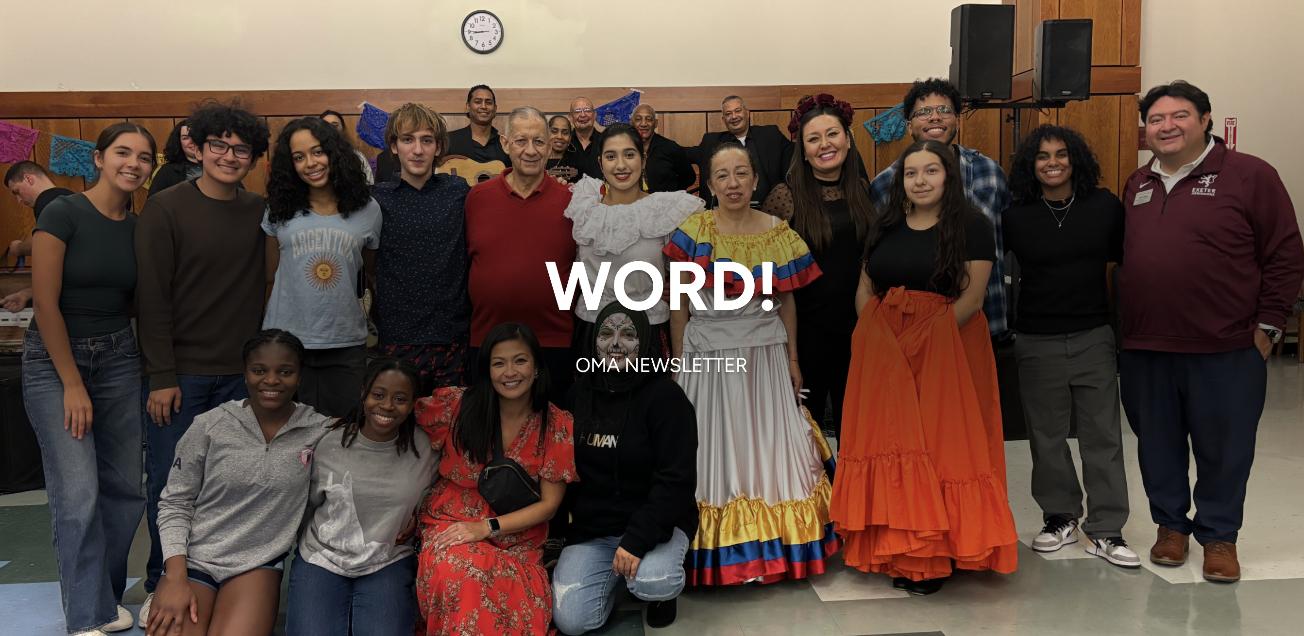 Students and faculty stand together celebrating Día de los Muertos